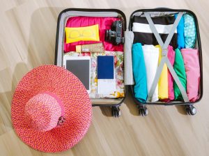Flat lay of essential travel items for short and long trips